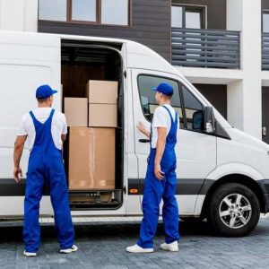 two-removal-company-workers-unloading-boxes-from-minibus-into-new-home_179755-17329